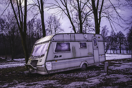 gray and black camping trailer parked near treee thumbnail