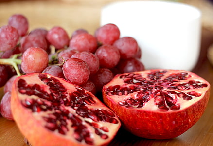 red grapes and round sliced fruit on table thumbnail