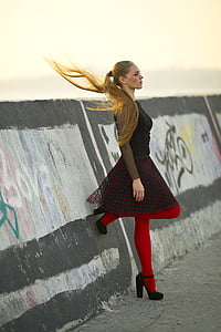 woman wearing black and red dress standing near concrete wall at daytime thumbnail
