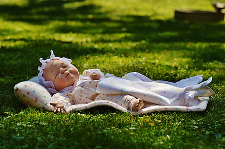 baby doll lying on mat outdoor thumbnail