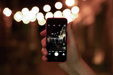 person holding pink iPhone 5c thumbnail