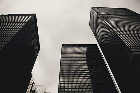 Low Angle Photography of Black High Rise Building Under Nimbus Clouds Background thumbnail