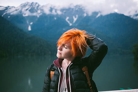 orange hair woman wearing black bubble jacket thumbnail