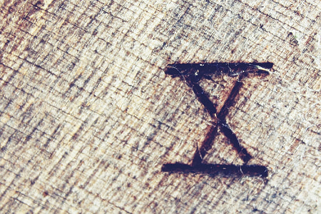 X mark on beige wooden surface thumbnail