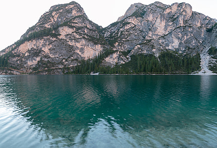rock cliff beside body of water thumbnail