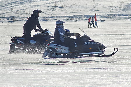 two men riding snowmobiles thumbnail