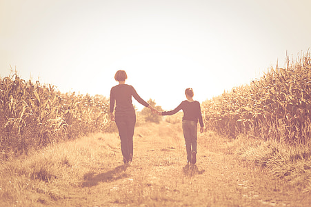 women walking on grass field thumbnail