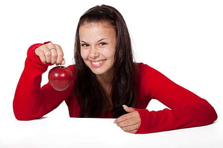 girl in red sweater smiling and holding an apple thumbnail
