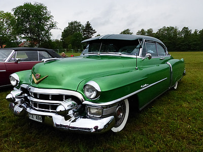 vintage green Chevrolet Impala parked on green grass during daytime thumbnail