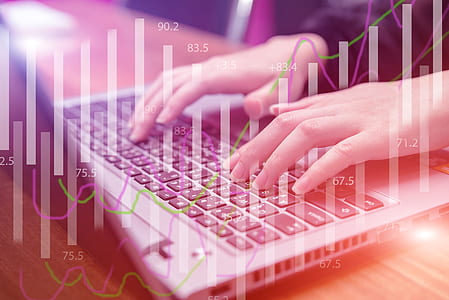 person operating laptop with bar graph background thumbnail
