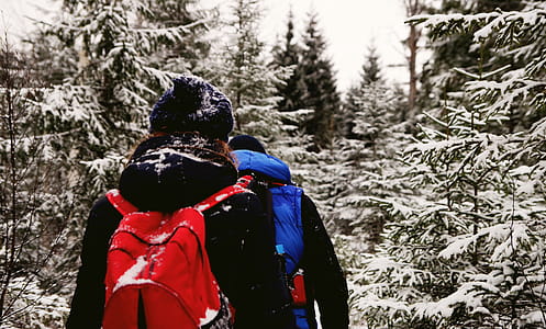 Two People Wearing Jacket And Red Backpack During Winter Season thumbnail