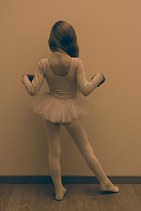 greyscale photo of ballerina facing on the wall thumbnail