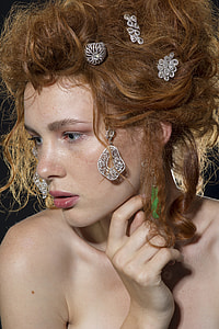 woman with brown curly hair and silver jewelry headdress thumbnail