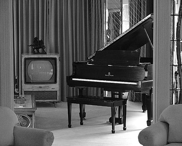 grayscale photography of upright piano near television thumbnail