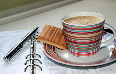 mug of coffee on saucer with cracker thumbnail