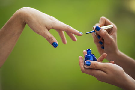person doing nail polish during daytime thumbnail