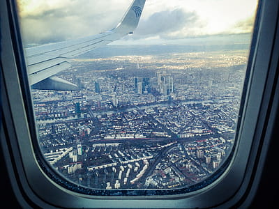 Airplane Windowpane Showing City Buildings thumbnail