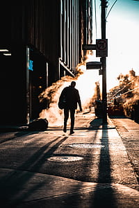 silhouette of person walking on walkway thumbnail