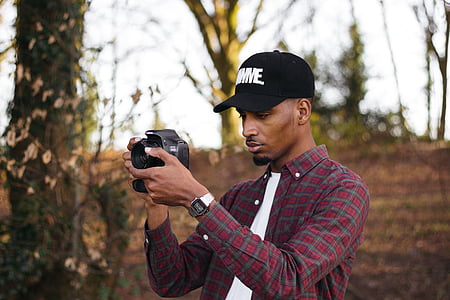 man holding DSLR camera thumbnail