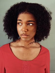 woman wearing red shirt looking towards right thumbnail