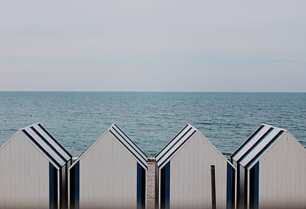 white houses near sea at daytime thumbnail