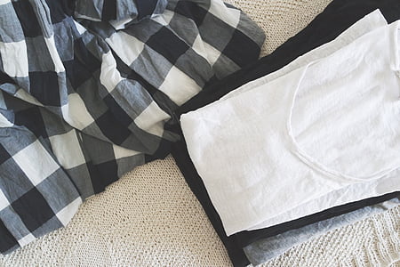 white scoop-neck shirt beside checkered textile on white textile thumbnail