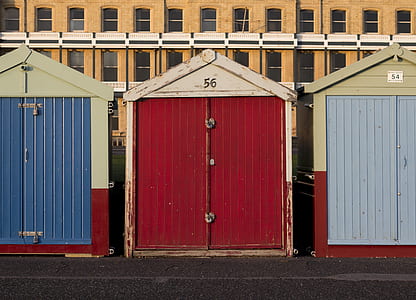 closed red shed between blue closed sheds thumbnail