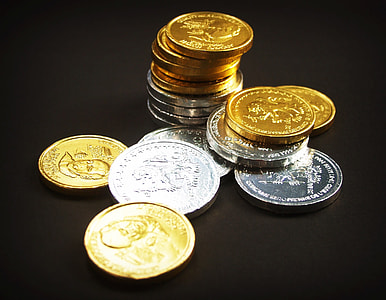 assorted round gold-colored and silver-colored coins on black surface thumbnail