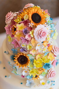 cake with white icing and flower candies thumbnail