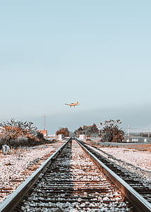 yellow and orange monoplane on flight on mid air taken at daytime thumbnail