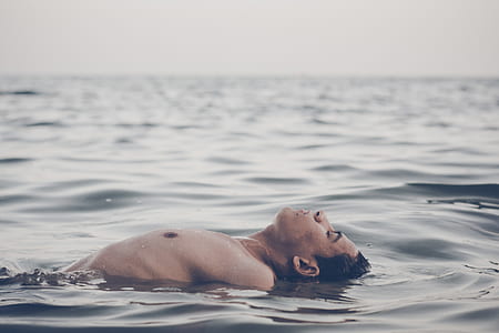 man floating on body of water thumbnail