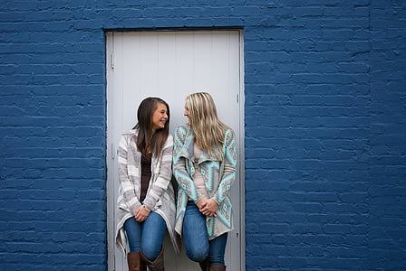 two woman standing leaning on the door thumbnail
