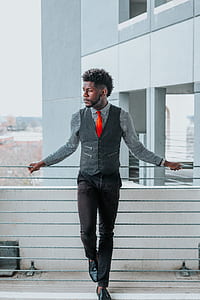 man standing beside fence thumbnail