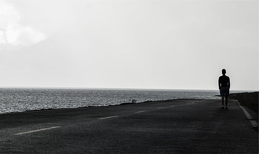 man walking near the bay thumbnail