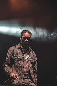 man holding microphone in dark room thumbnail