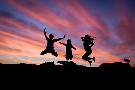 silhouette of three people jumping during sunset thumbnail