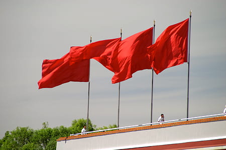 four red flags on poles thumbnail