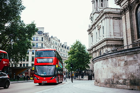 Red double decker bus on London road traffic signal thumbnail