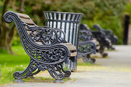 black steel bench near trashcan during daytime thumbnail