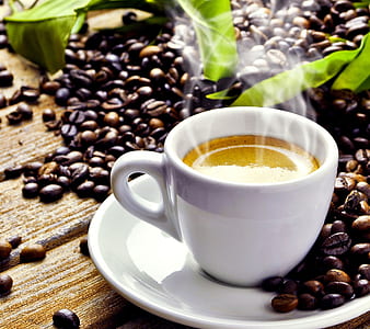 white ceramic mug on saucer and coffee bean lot thumbnail