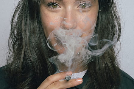 woman in black top smoking cigarette thumbnail