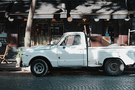 white single cab truck parked beside store thumbnail