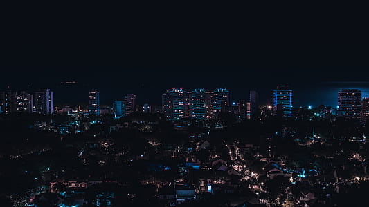 aerial concrete buildings at nighttime thumbnail