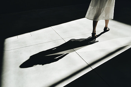 woman in white dress with shadow thumbnail