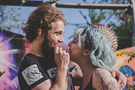 man and woman face to face while woman closing both eyes at daytime thumbnail