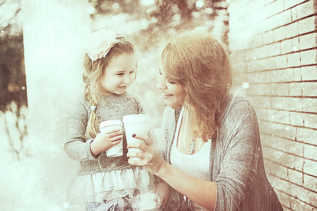 smiling woman and child holding disposable cups thumbnail