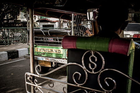 person driving auto rickshaw during daytime thumbnail