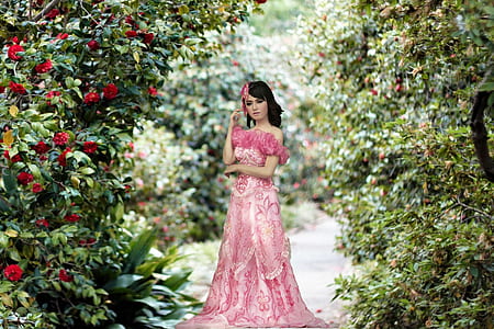 photo of woman wearing pink dress in the middle of flowers thumbnail