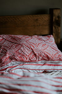 close-up photography of red and white floral pillow thumbnail