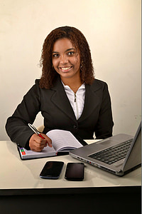 woman in black formal coat holding a silver and red click pen thumbnail